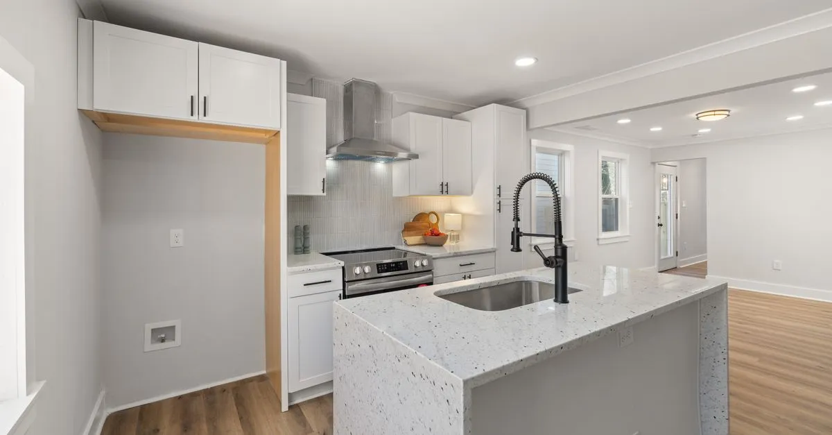 Stylish kitchen featuring granite countertops, stainless steel appliances, and hardwood flooring.